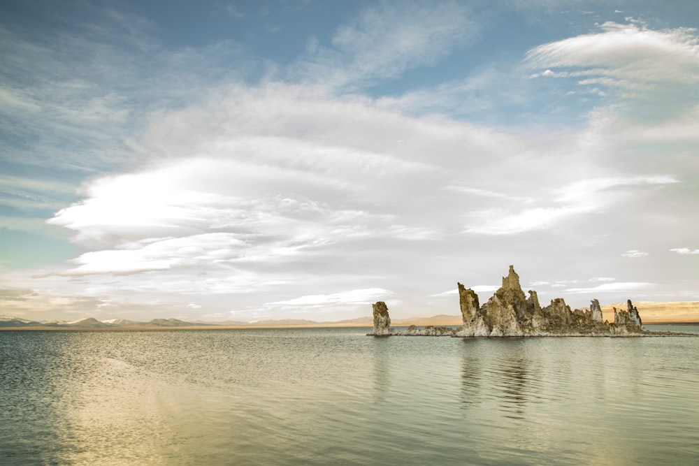 rock formation near calm body of water