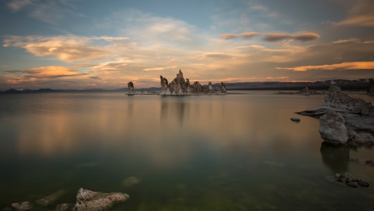 gray rock formation under white and blue sky during daytime photography in Mono Lake United States