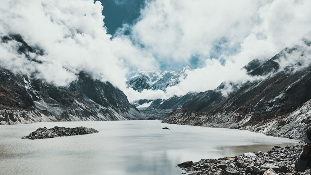 body of water surrounded by mountain range