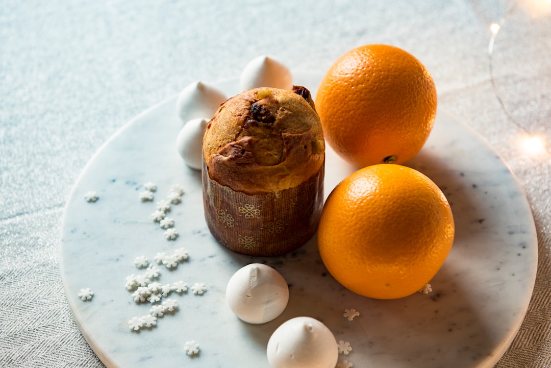 two orange fruits on white plate