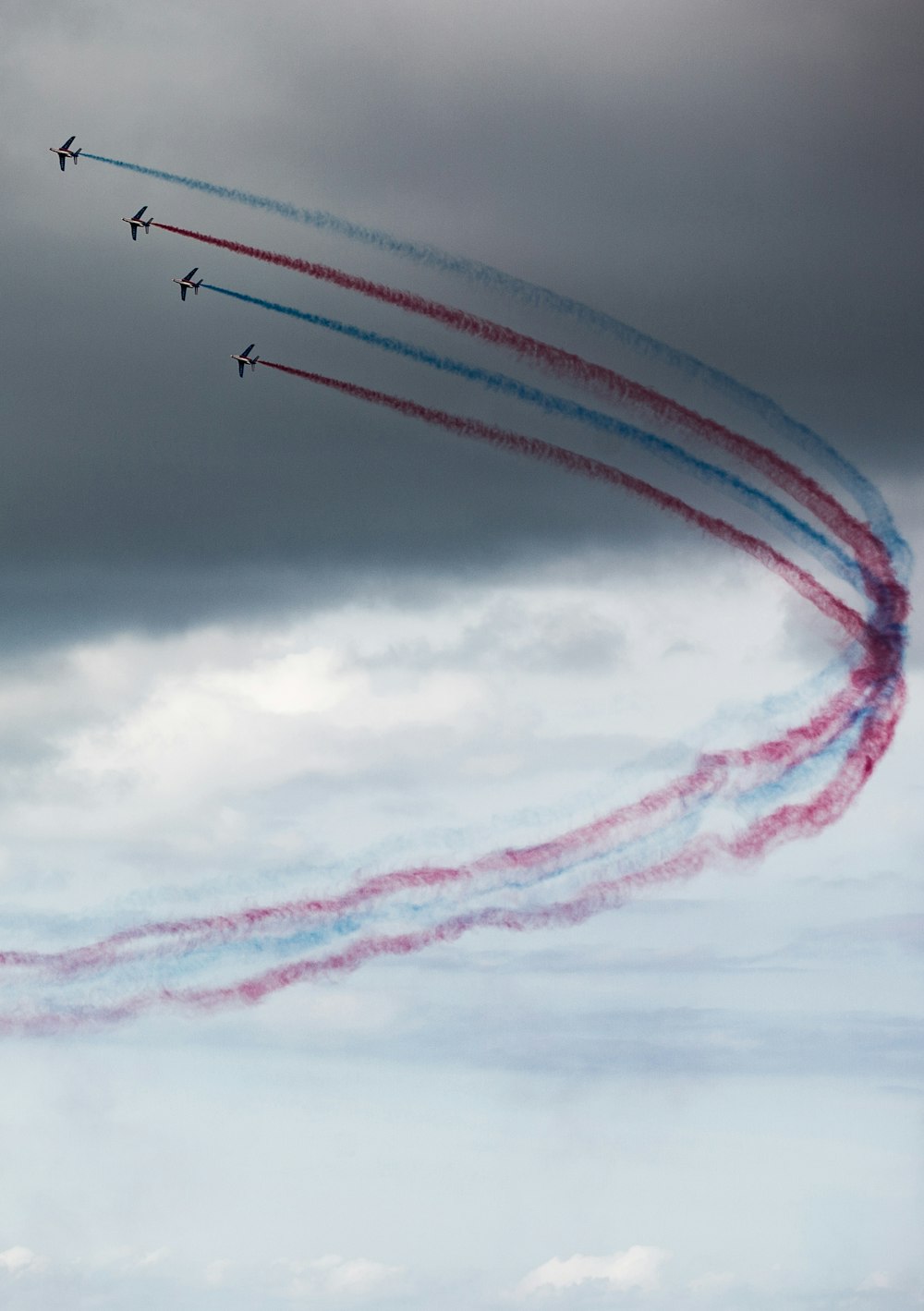 a group of airplanes flying through a cloudy sky