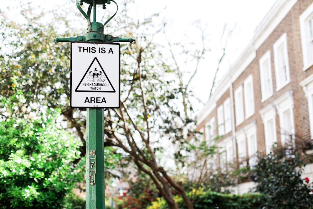 This is a neighbourhood area sign on green post