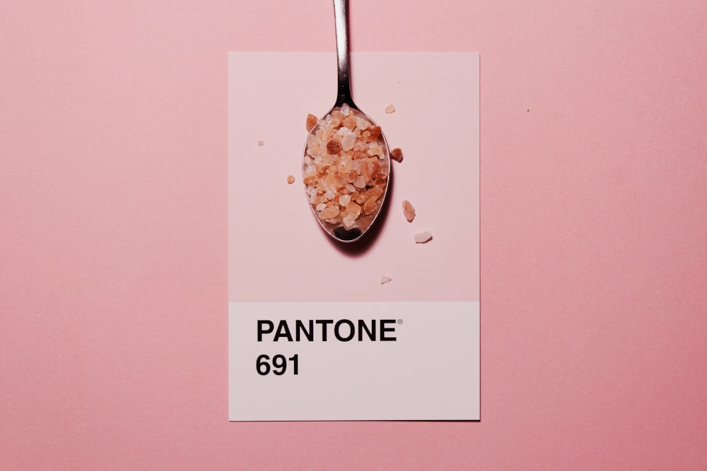 silver spoon with Pantone 691 text overlay