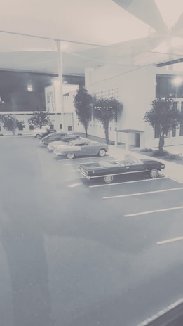 Front view of Garage Quinsac Auto with vintage and modern cars parked outside.