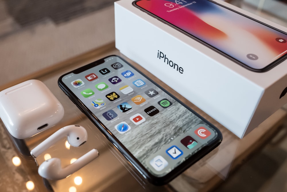 A space gray iPhone X with box.