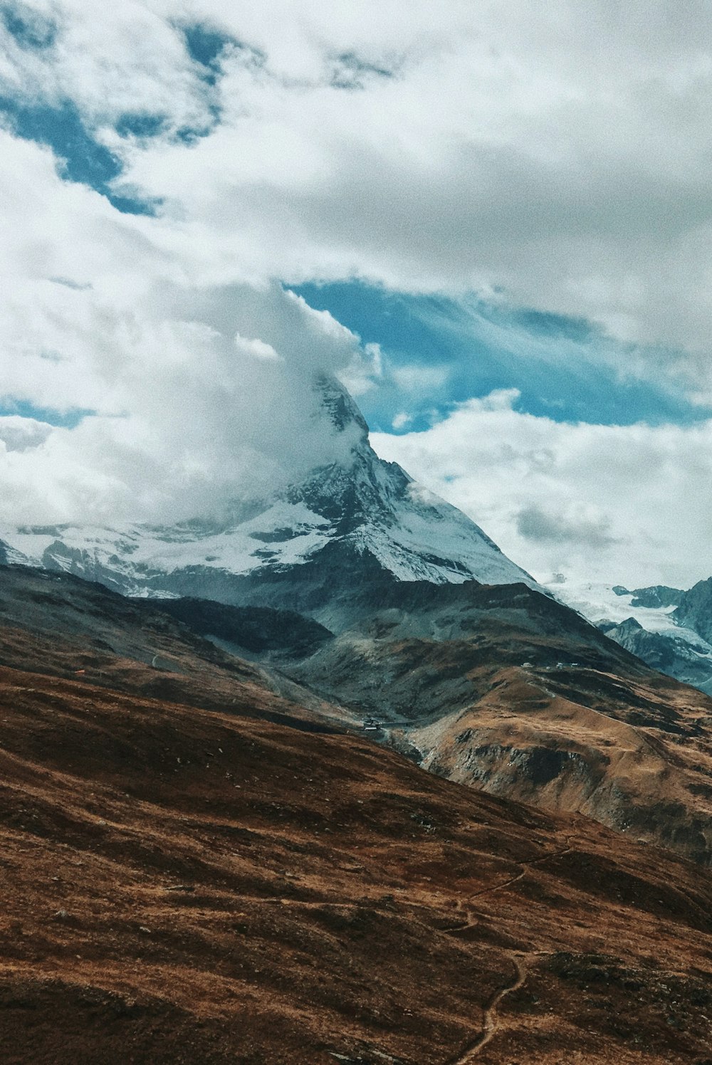 snow-capped mountain covered in cloud
