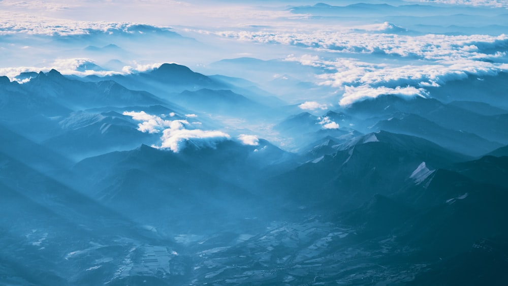 mountain covered with fogs during daytime