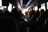 people riding passenger bus during daytime