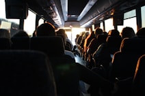 people riding passenger bus during daytime