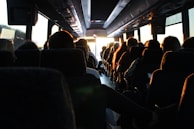 people riding passenger bus during daytime