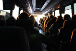 people riding passenger bus during daytime