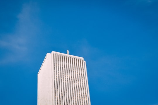 low angle photo of white high-rise building under blue sky in Millennium Park United States