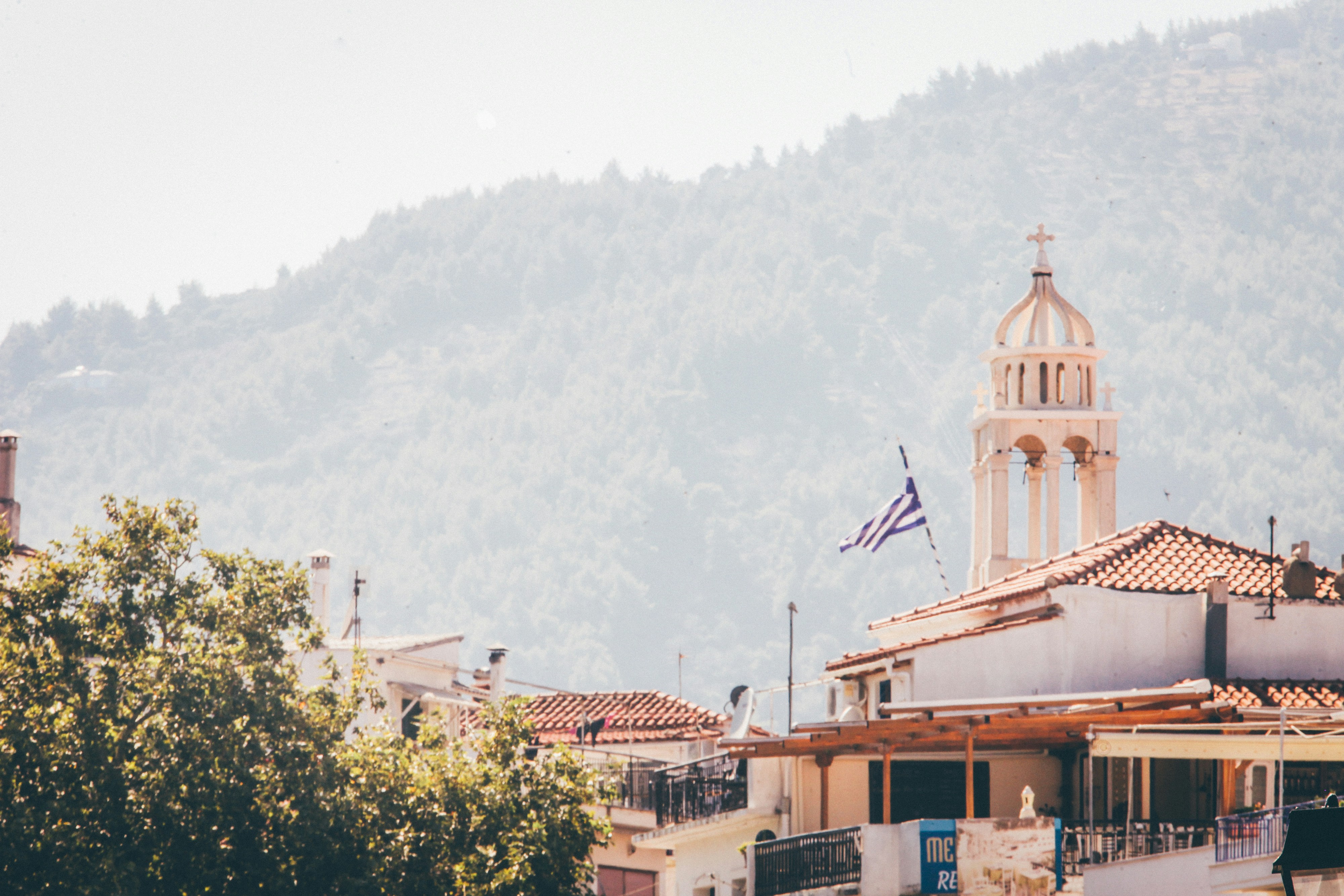 white concrete building near mountain at daytime
