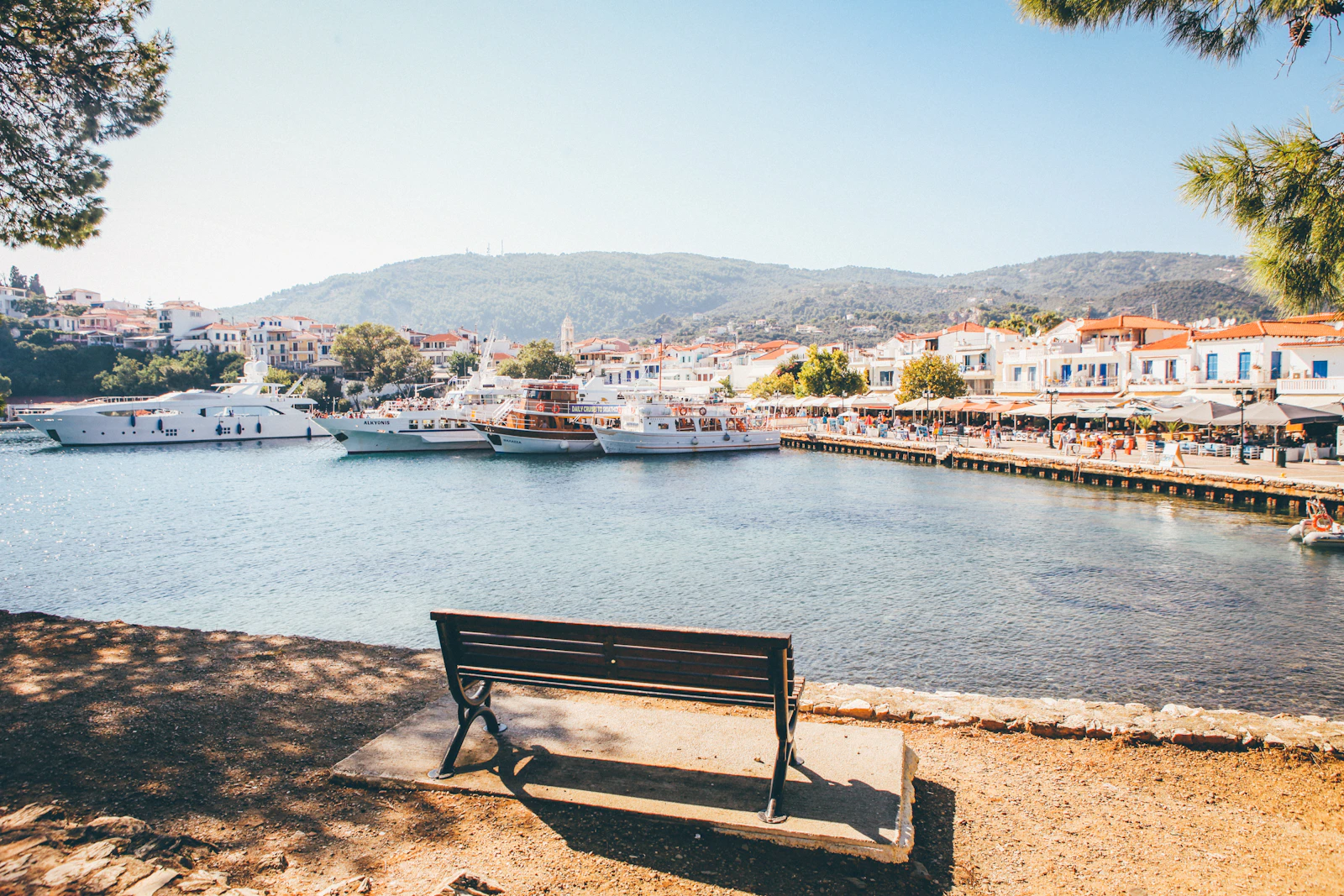 A wooden bench on the waterfront at Skiathos town