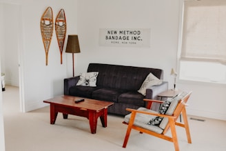 rectangular brown wooden coffee table near black 3-seat sofa