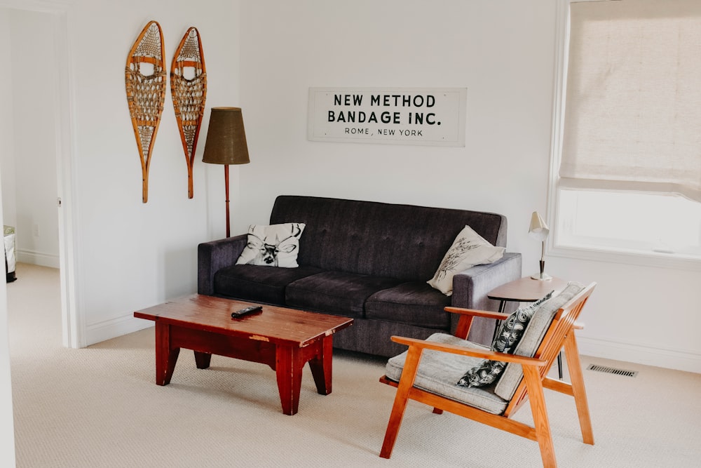 rectangular brown wooden coffee table near black 3-seat sofa