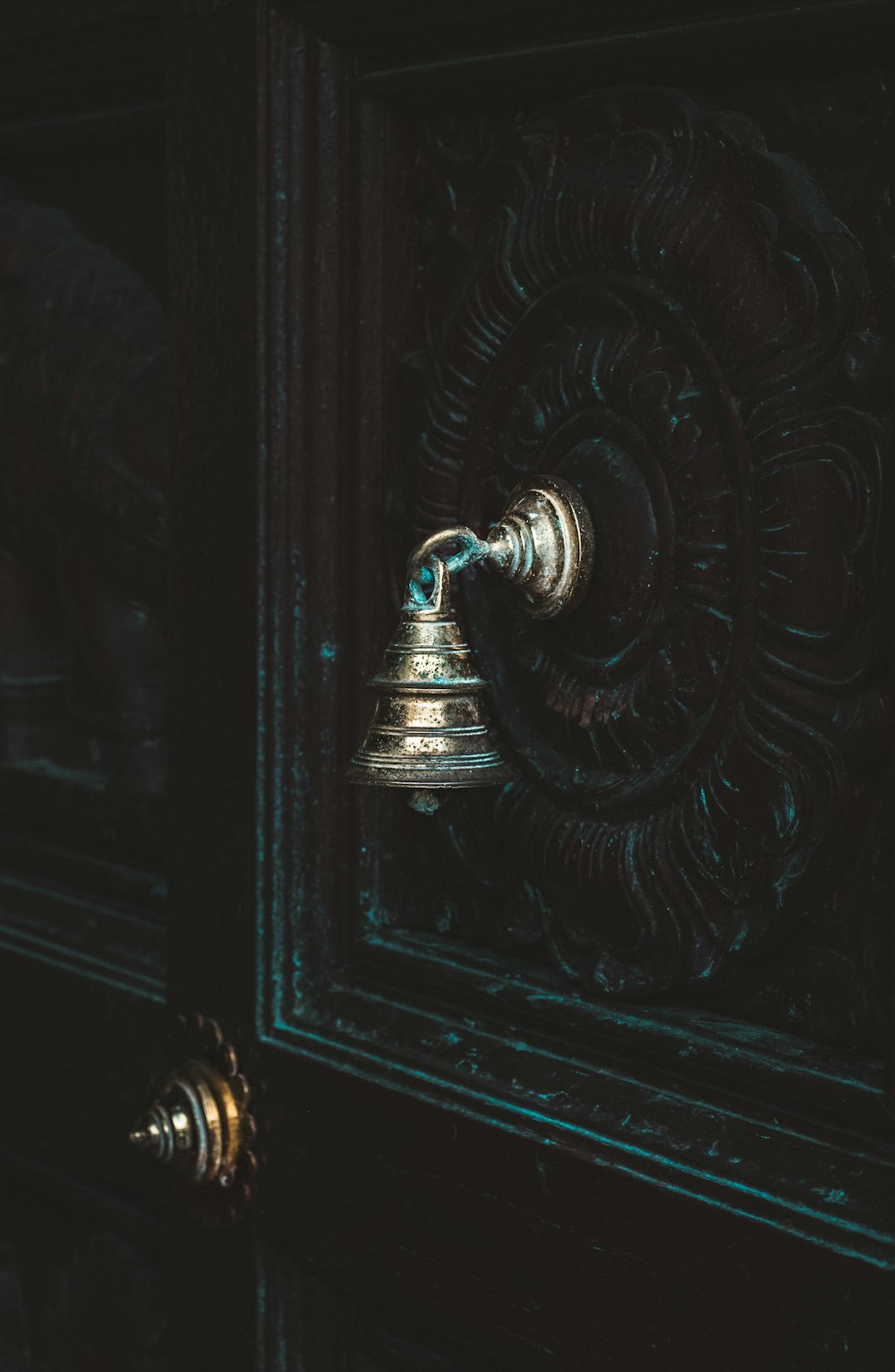 silver-colored door bell on black door