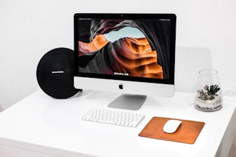 silver iMac with Apple Magic Keyboard and Magic Mouse