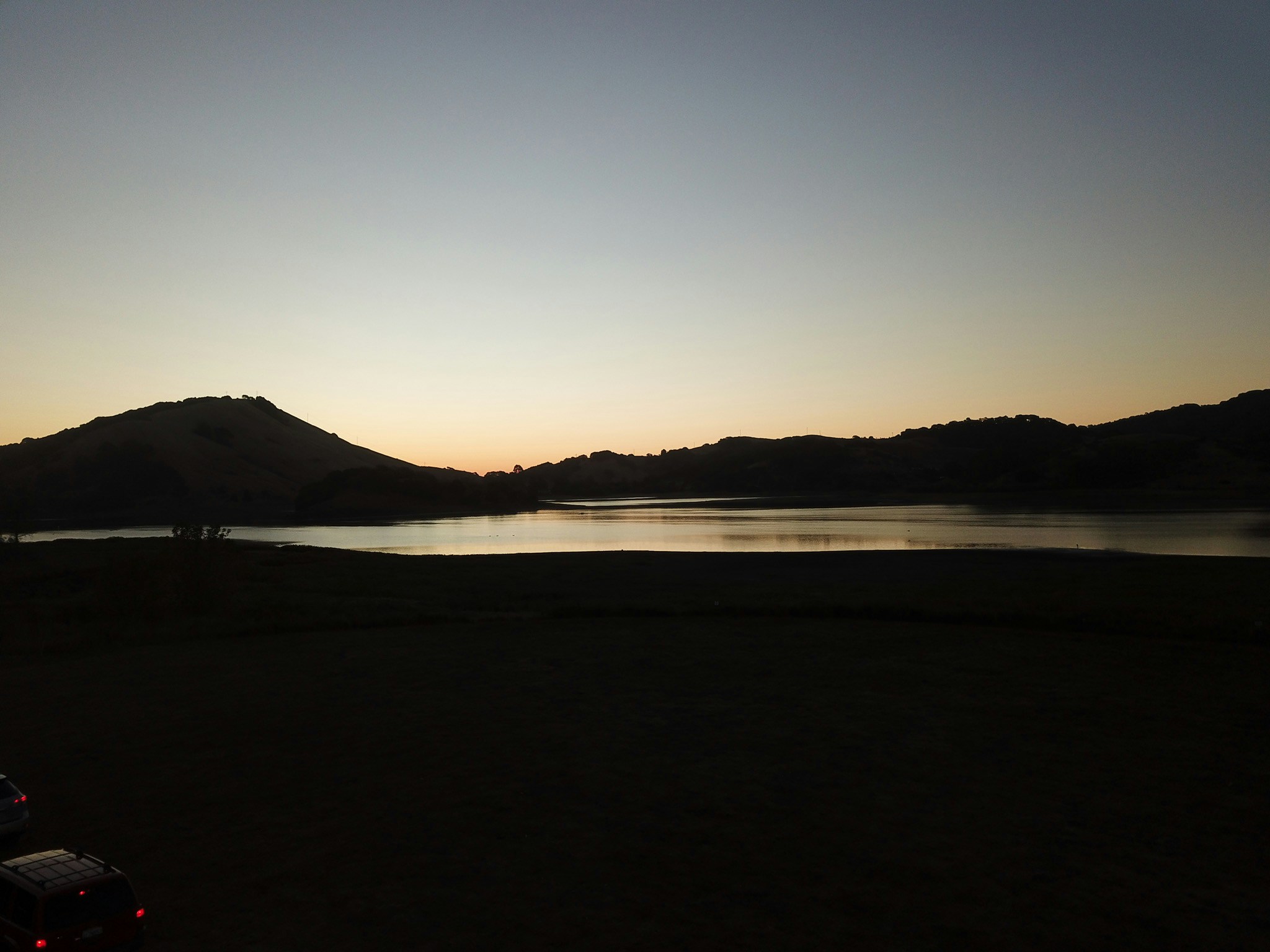 silhouette of mountain and lake