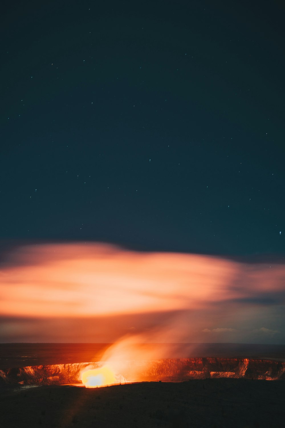 bonfire surrounded by rocky cliff at nighttime