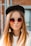 woman in white knit sweater and black fitted cap