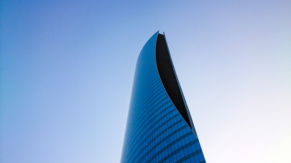 blue and black high-rise building under white sky at daytime