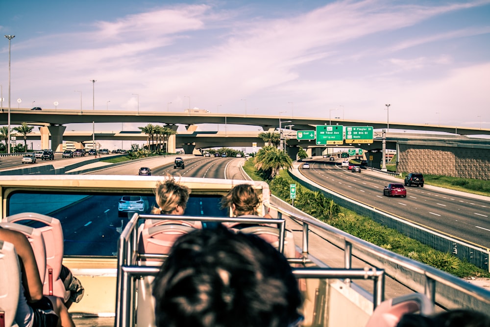 group of people sitting on top of double-decker bus