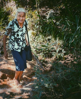 An elderly person happily wearing pomelo footwear while walking.