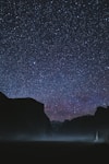 silhouette of mountains during starry night