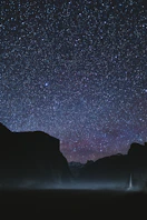 silhouette of mountains during starry night