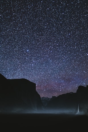 silhouette of mountains during starry night