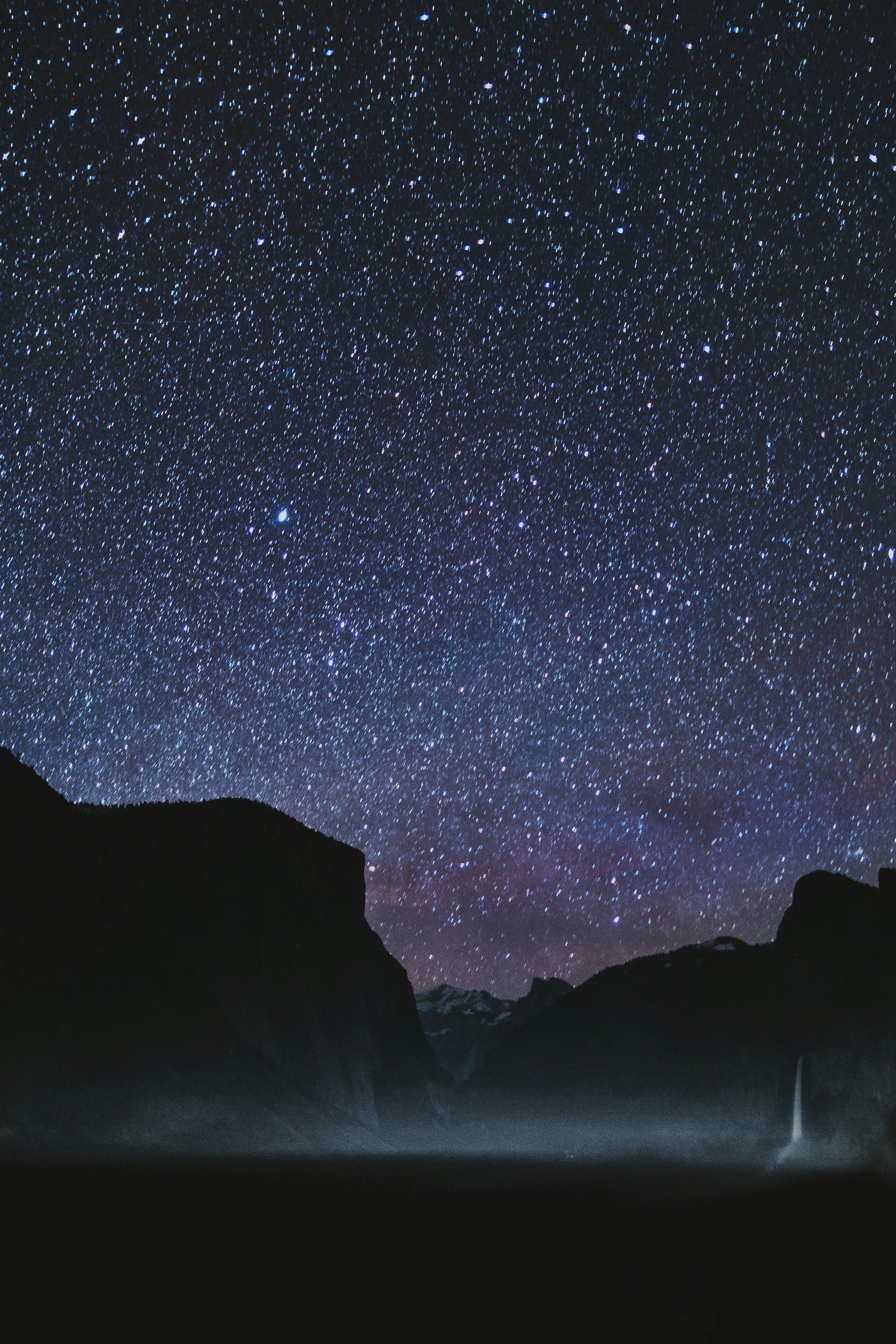 silhouette of mountains during starry night