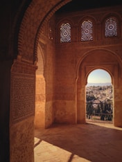 a view of a city through an arch in a building