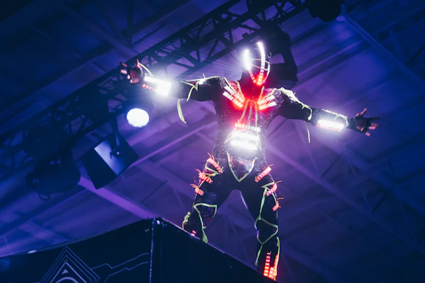A superhero striking a heroic pose on stage during a lively corporate event.