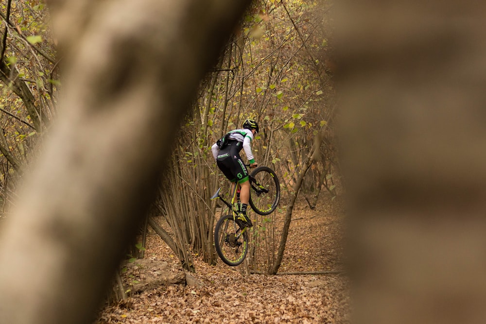 man riding on black mountain bike