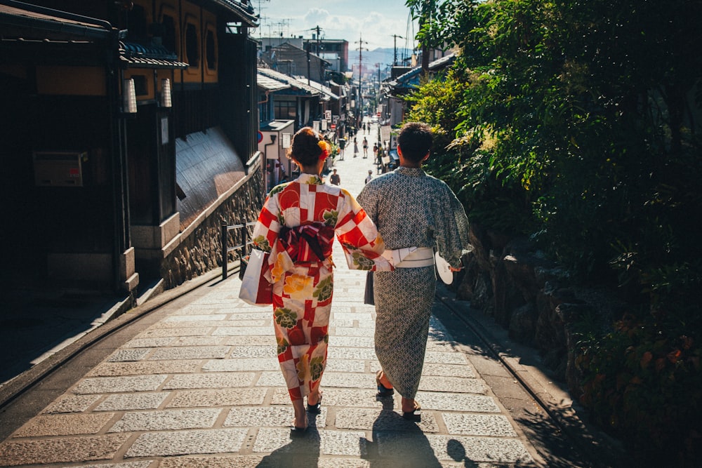 man and woman walking on the road