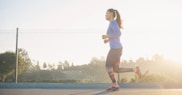 woman jogging near wire fence
