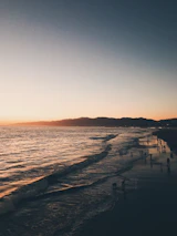 Sunset view of Marina Beach with people enjoying the evening breeze.