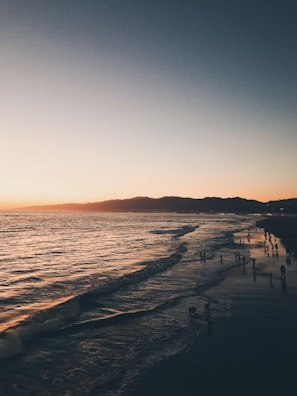 A scenic view of a tranquil beach at sunset.