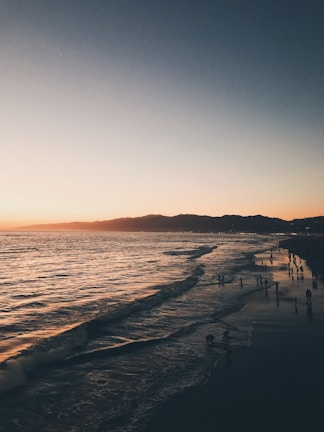 A scenic view of a tranquil beach at sunset.
