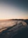 A scenic beach view with a couple enjoying the sunset.