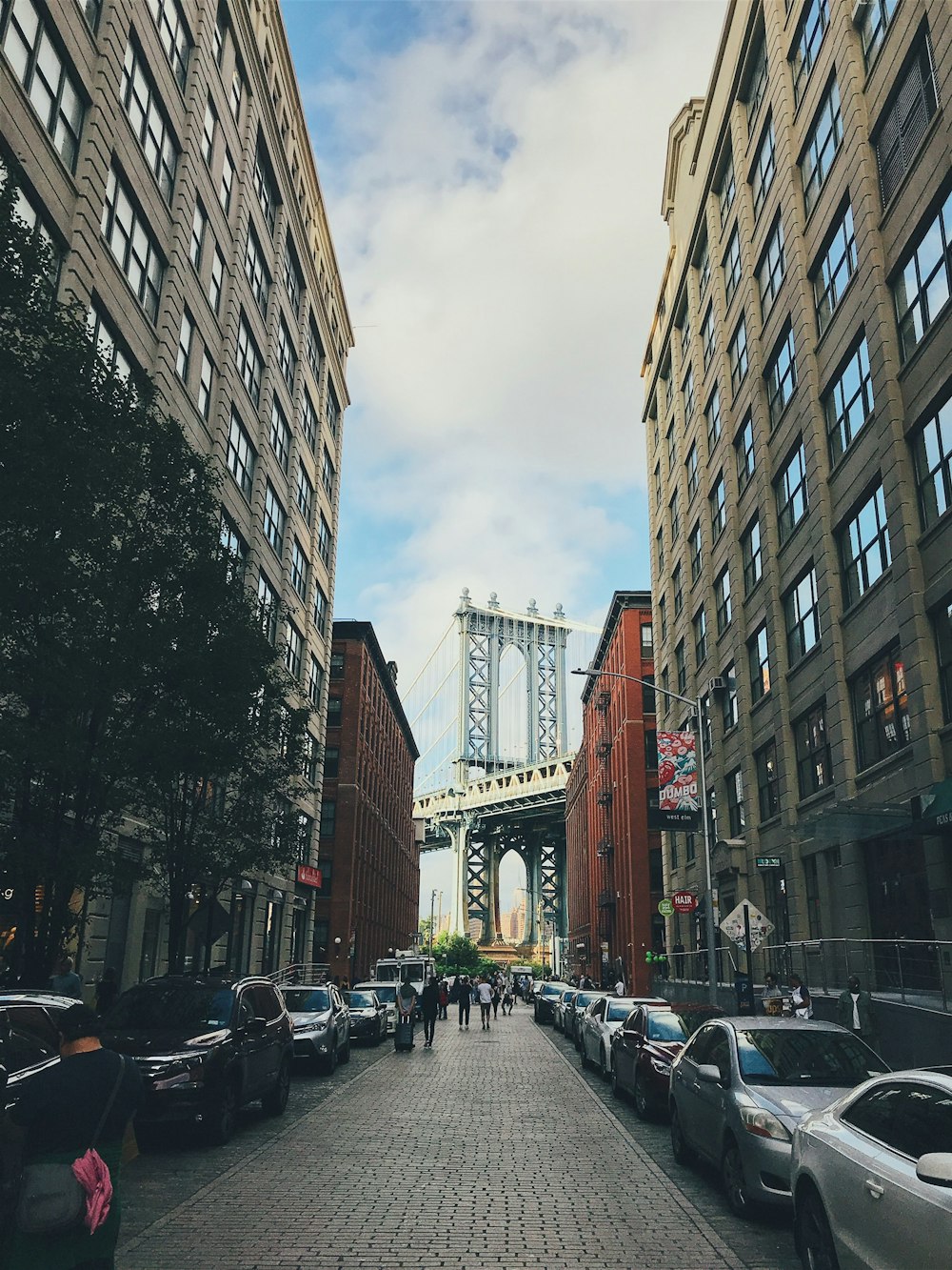 group of people walked in street in front of Manhattan bridge