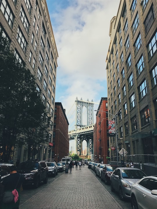 group of people walked in street in front of Manhattan bridge in Brooklyn Bridge Park United States