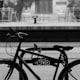 grayscale photography of bicycle lock on bike rack