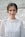 shallow focus photo of woman standing near wall