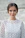 shallow focus photo of woman standing near wall
