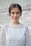 shallow focus photo of woman standing near wall