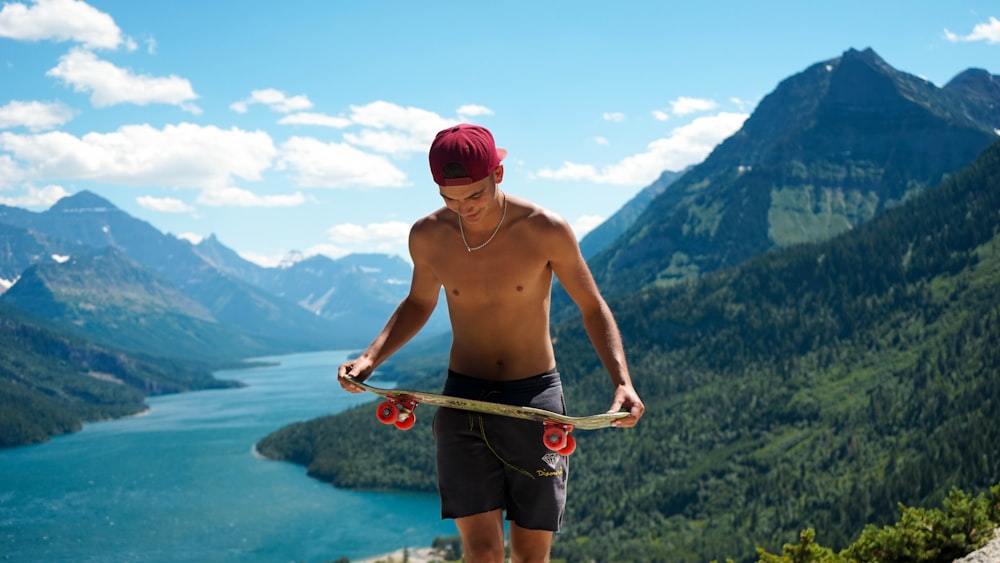 man holding gray skateboard