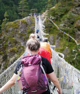 people on hanging bridge during daytime