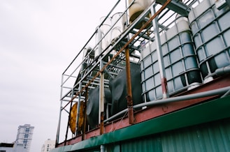 white IBC tanks on green building